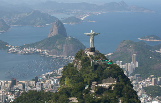 Christ the redeemer overlooks Rio and Sugarloaf Mountain on Brazil's coastline.