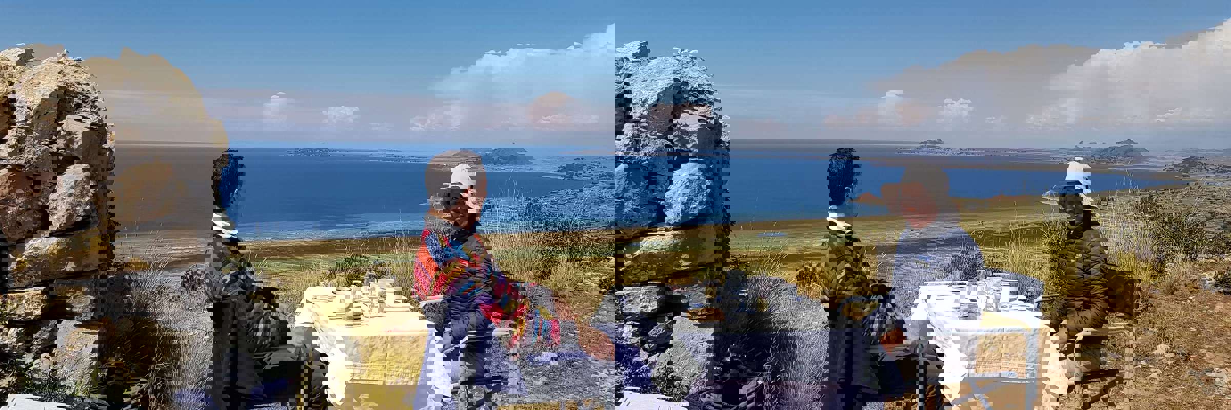 Private picnic setup with panoramic views of Lake Titicaca in the Peruvian highlands. 