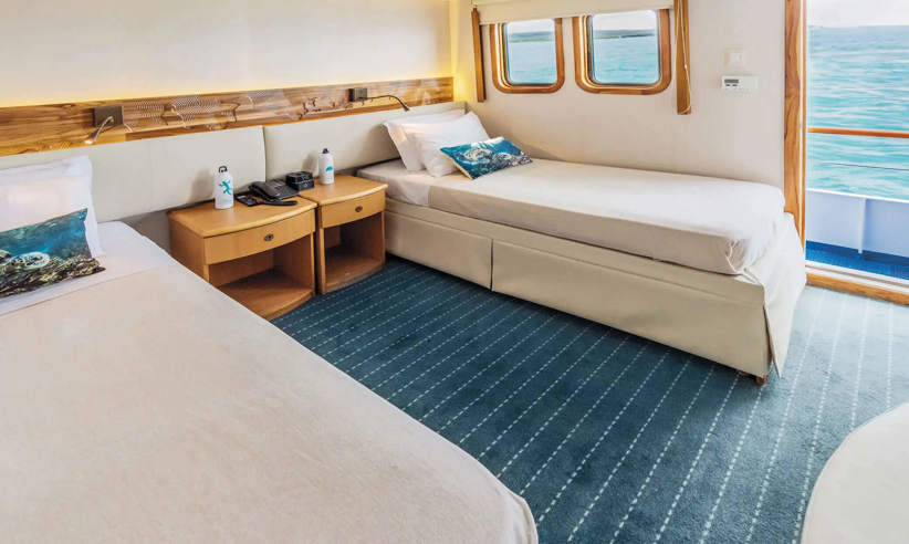 A spacious outside facing junior twin cabin on Coral I